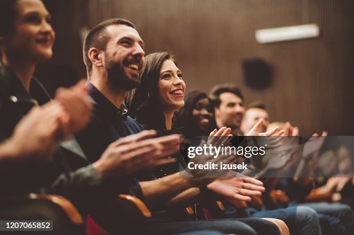 Happy audience applauding in the theater Happy audience applauding in the theater