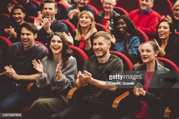 happy audience applauding in the theater - comedian audience stock pictures, royalty-free photos & images