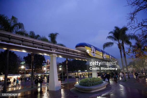 Monorail passes overhead as guests exit Walt Disney Co.'s Disneyland theme park in Anaheim, California, U.S., on Friday, March 13, 2020. Fans in...