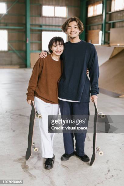 two skateboarders laughing - couple full length stock pictures, royalty-free photos & images
