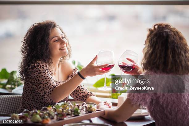 young lesbian couples having dinner - lesbian date stock pictures, royalty-free photos & images