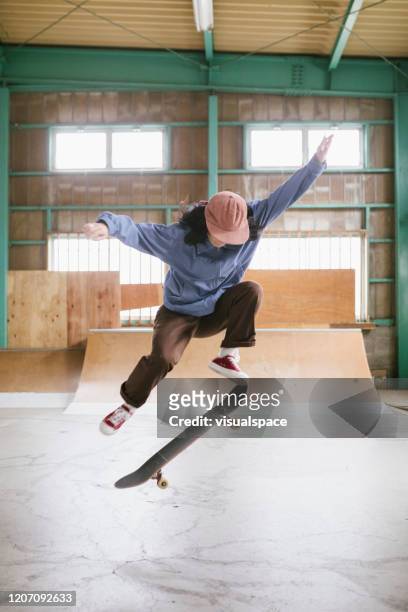 skateboarder in mid-air ollie - skating stock pictures, royalty-free photos & images