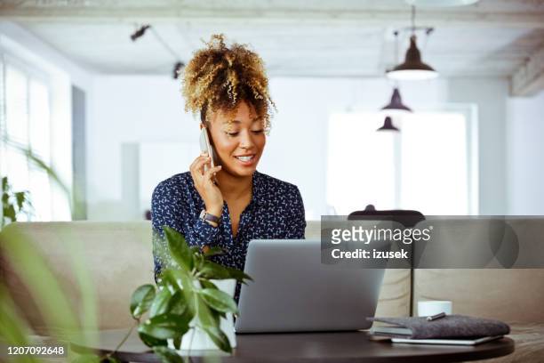 businesswoman dealing with client through phone - answering stock pictures, royalty-free photos & images