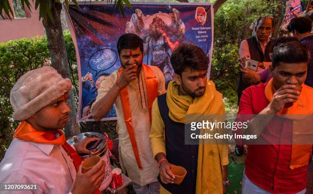 Members and supporters of 'Akhil Bharat Hindu Mahasabha' a Hindu organisation, drink cow urine as they attend a 'gaumutra party' to fight against the...