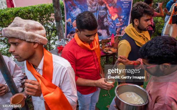 Member and supporter of 'Akhil Bharat Hindu Mahasabha' a Hindu organisation distributes panchagavya, a traditional Hindu ritual mixture made of cow...
