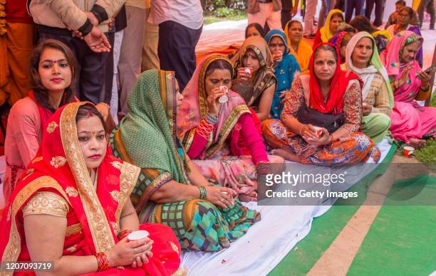 Women members and supporters of 'Akhil Bharat Hindu Mahasabha' a Hindu organisation, drink tea made with cow urine during a 'gaumutra party' to fight...