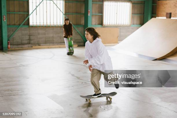 female skateboarder in skatepark - skater girl stock pictures, royalty-free photos & images