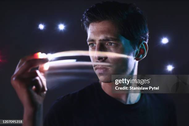 portrait of man moving lights in his hand - long exposure people stock pictures, royalty-free photos & images