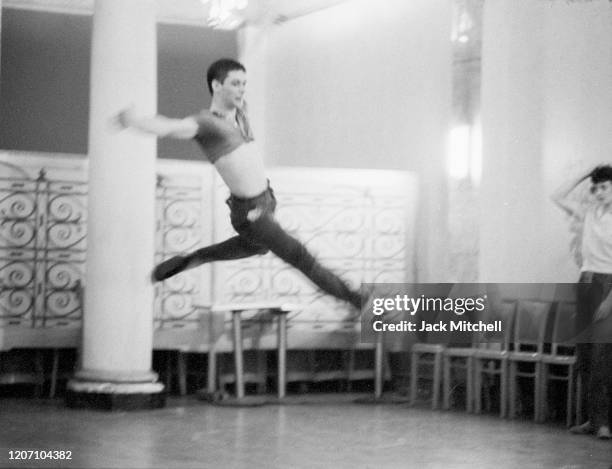 Dancer Dirk Sanders jumps during backstage rehearsals for Mary Martin's Easter Sunday live color telecast , 1959.