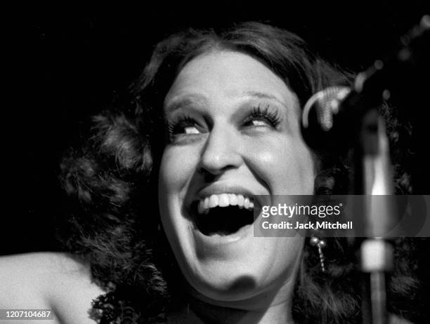 Close-up of American singer and actress Bette Midler as she performs onstage during her 'Continental Baths' tour, New York, New York, 1972.