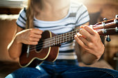 Closeup of teenage girl playing ukulele