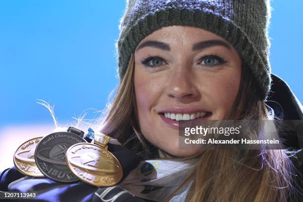 Dorothea Wierer of Italy poses with her the two gold medals and her silver medal after the medal ceremony for the Women 15 km Individual Competition...