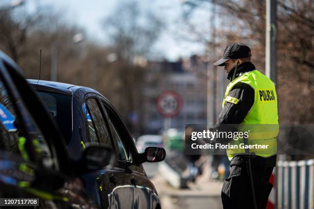 Police officer checks people crossing the border between Zgorzelec and Goerlitz on March 14, 2020 in Zgorzelec, Poland. Poland and Czech Republic...