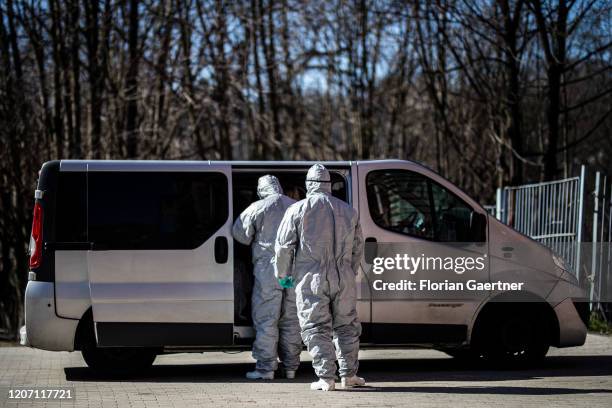 Two men with protective clothing check body temperature of people crossing the german-polish border on March 14, 2020 in Zgorzelec, Poland. Poland...