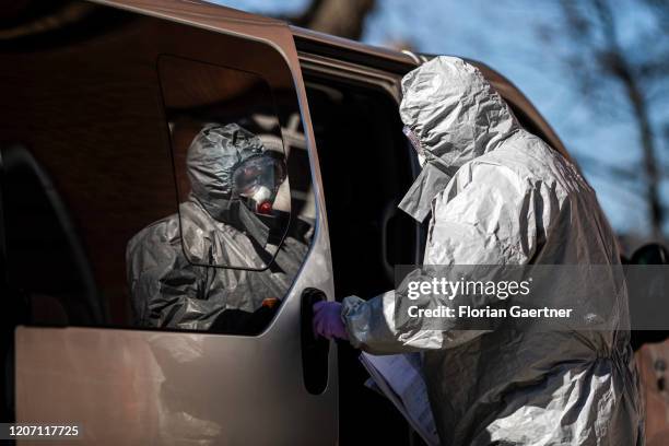 Man with protective clothing check people crossing the german-polish border on March 14, 2020 in Zgorzelec, Poland. Poland and Czech Republic decide...