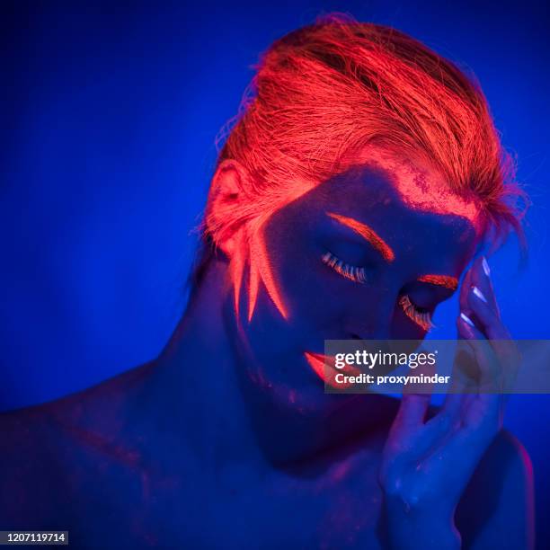 uv ultraviolet light women portrait - neon fluorescent hair stock pictures, royalty-free photos & images