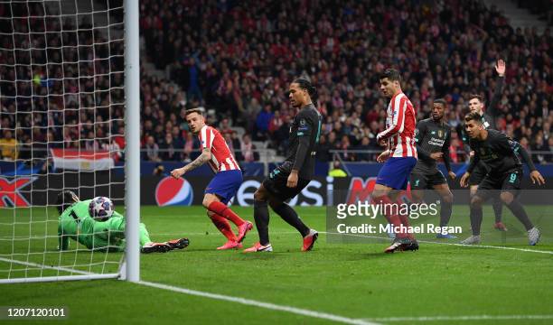 Saul Niguez of Atletico Madrid scores his team's first goal past Alisson Becker of Liverpool during the UEFA Champions League round of 16 first leg...