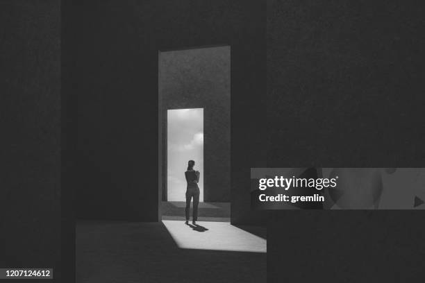 woman standing between passages - abstract photography stock pictures, royalty-free photos & images