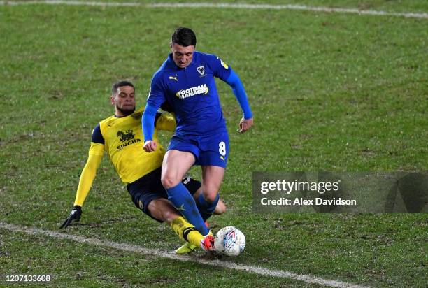 Marcus Browne of Oxford United tackles Anthony Hartigan of AFC Wimbledon during the Sky Bet League One match between Oxford United and AFC Wimbledon...