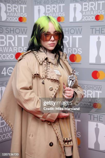 Billie Eilish poses with the International Female Solo Artist award in the winners rooms at The BRIT Awards 2020 at The O2 Arena on February 18, 2020...