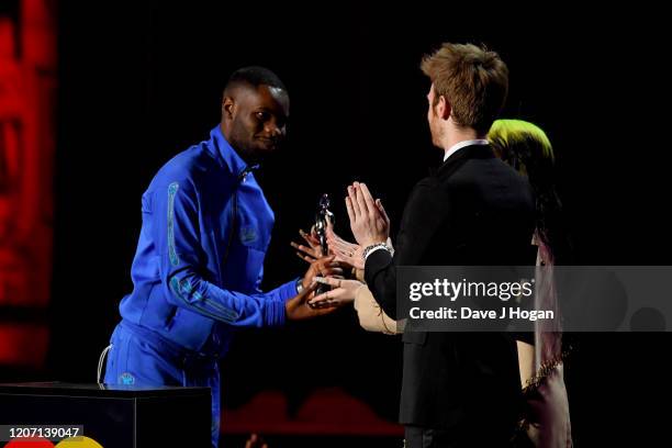 Dave is presented Mastercard Album of the Year by Billie Eilish and Finneas O'Connell at The BRIT Awards 2020 at The O2 Arena on February 18, 2020 in...