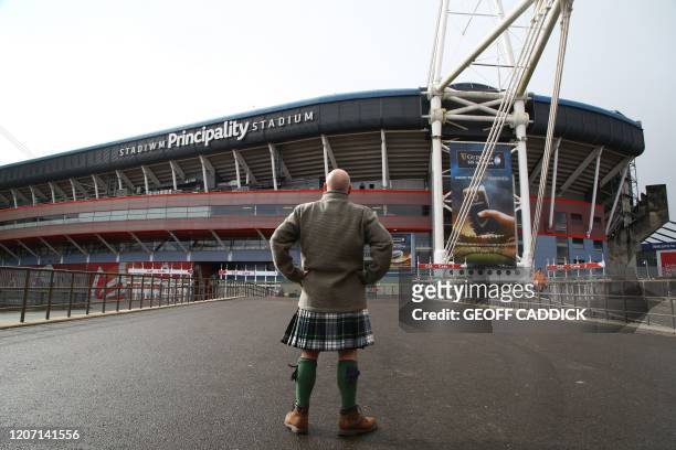 Man in a kilt stands in front of the Principality Stadium in Cardiff, Wales on March 14, 2020. - This weekend's Six Nations international between...