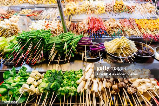 various street food on a market stall in chinatown of kuala lumpur, malaysia - kuala lumpur stock pictures, royalty-free photos & images