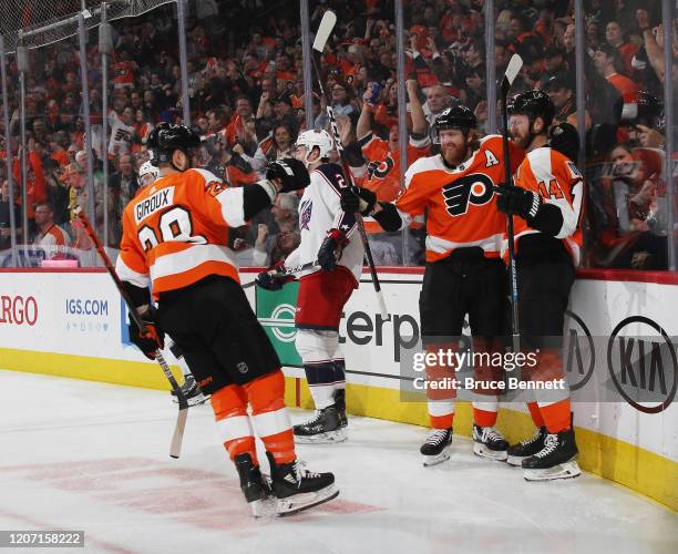 Philadelphia Flyers center Sean Couturier scores at 4:30 of the first period against the Columbus Blue Jackets and is joined by center Claude Giroux...