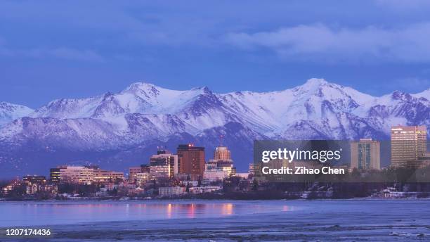 city skyline by the snow mountains - アンカレッジ ストックフォトと画像