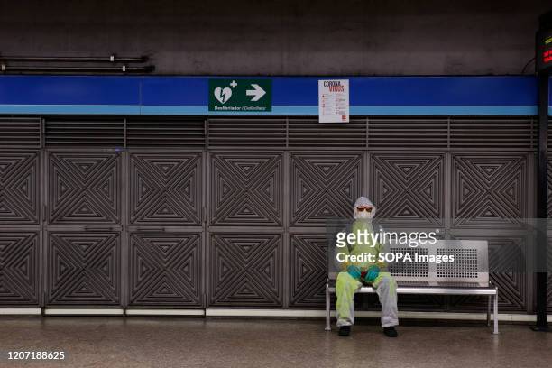 Man wears protective clothing and face mask as a preventive measure against the coronavirus in a metro station. Spain has declared the state of...