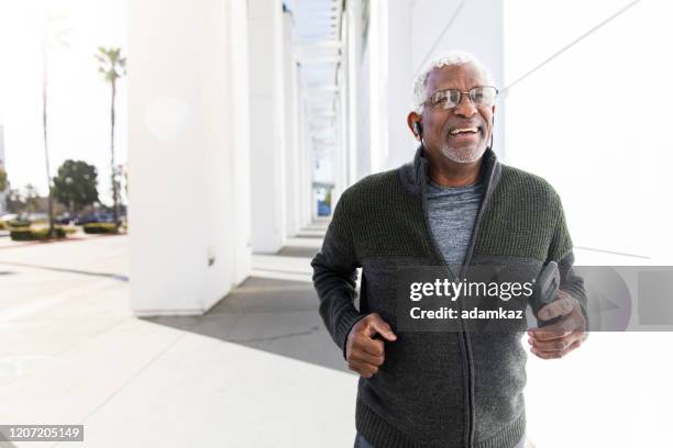 senior black man jogging - running man heartbeat stock pictures, royalty-free photos & images