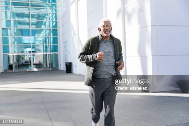 senior black man jogging - running man heartbeat stock pictures, royalty-free photos & images