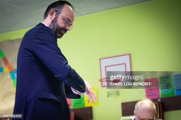 French Prime minister and candidate running as Le Havre's city mayor Edouard Philippe rubs his hands after casting his vote during the first round of...