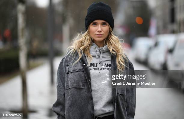 Scarlett Gartmann wearing Off White jacket, Helmut Lang sweater, YSL bag, Chanel beanie and Zara pants on February 18, 2020 in Dusseldorf, Germany.