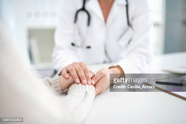 providing compassion during difficult times - examination closeup stock pictures, royalty-free photos & images