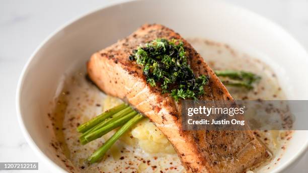 baked salmon with mashed potato and asparagus, creamy sauce - fish dinner stock pictures, royalty-free photos & images