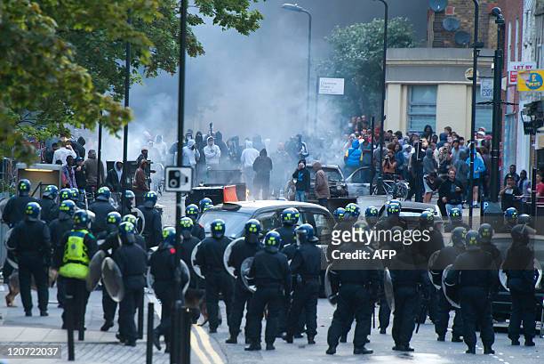 Riot police face a mob in Hackney, north London on August 8, 2011. Riot police faced off with youths in fresh violence in London today in the third...
