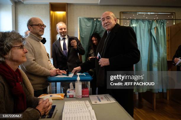 Outgoing mayor of Lyon and candidate for the metropolitan election Gerard Collomb casts his vote during the first round of municipal elections in...