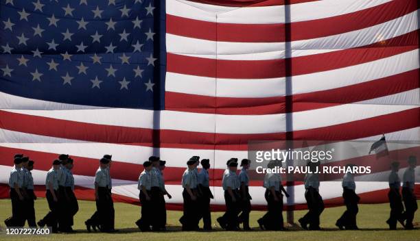 Troops march past a large American flag as they graduate from Basic Combat Training at Fort Jackson, South Carolina 02 November 2007.