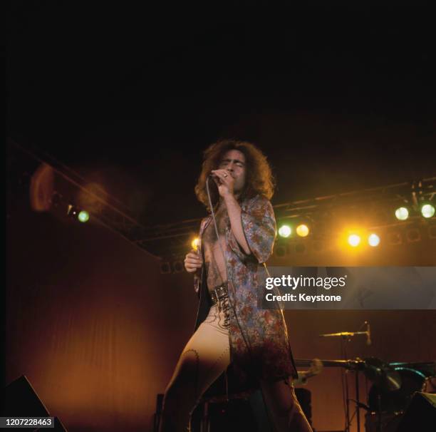 British singer Paul Rodgers, bare chested and wearing a floral print robe, as his band, Bad Company perform live at the 1976 Great British Music...