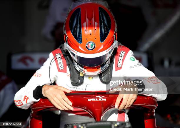 Robert Kubica of Poland and Alfa Romeo Racing prepares to drive in the garage during day one of Formula 1 Winter Testing at Circuit de...