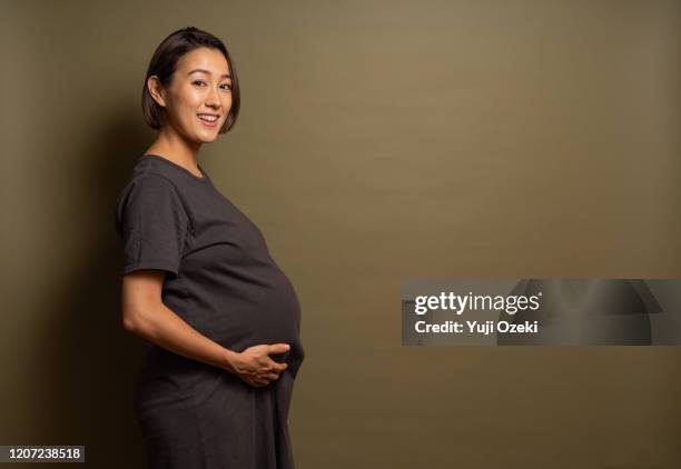 studio portrait of asian pregnant woman - future proof stock pictures, royalty-free photos & images