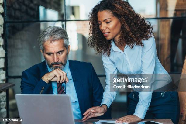 discussing the report with the ceo - director office stock pictures, royalty-free photos & images