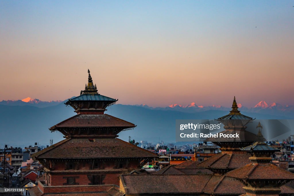 Religious buildings at sunset overlooking the Himalayas