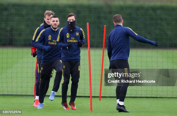 Mesut Ozil of Arsenal warms up during a Arsenal Training Session at London Colney on February 19, 2020 in St Albans, England.