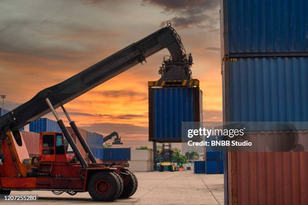 crane loading container box to logistics truck for exports in container port - docklands studio stock pictures, royalty-free photos & images