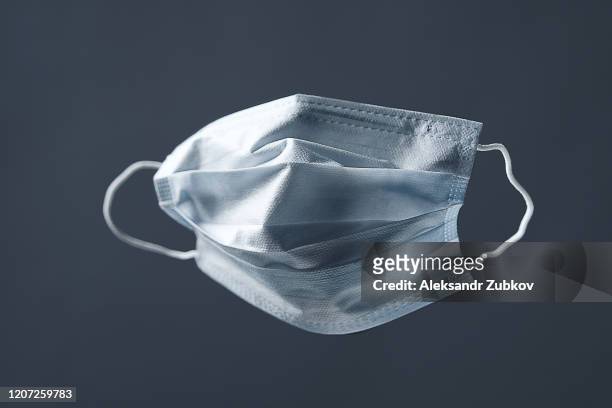 medical used face mask, protects against virus. concept of air pollution, pneumonia outbreaks, coronavirus epidemics, and the risk of biological contamination. - air pollution mask stockfoto's en -beelden
