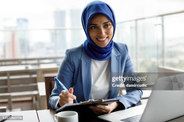 muslim woman on business meeting - islamic finance stock pictures, royalty-free photos & images