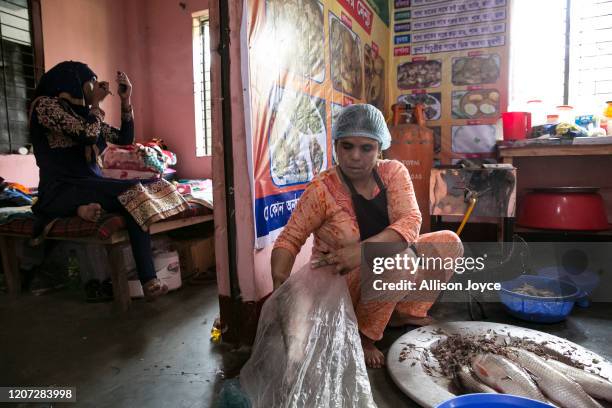 Dalia does makeup while Zubaida cooks fish on March 9, 2020 in Dhaka, Bangladesh. Zubaida returned from Saudi Arabia in 2019. "My financial situation...