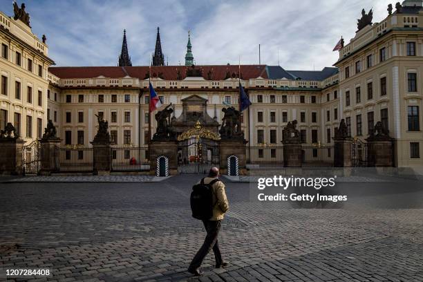 Man walks across an empty Hradcany Square in front of closed Prague castle on March 16, 2020 in Prague, Czech Republic. The Czech government has...